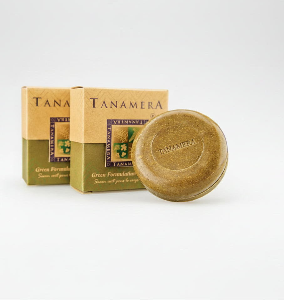 Tanamera Green Formula body soap bar shown in front of its retail box packaging on a white background, with two small line-drawn icons on the right describing benefits.