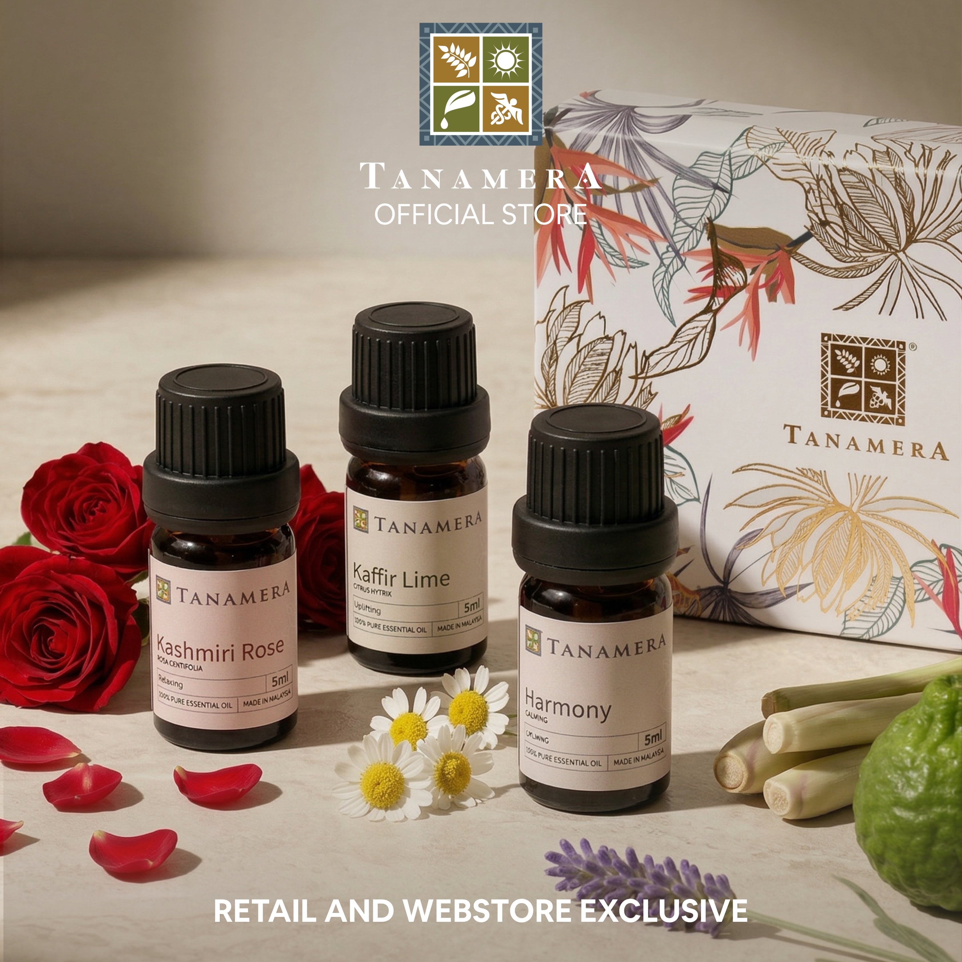 Tanamera essential oil bottles with packaging and flowers on a wooden surface