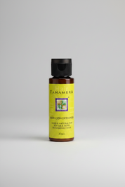Tanamera hair conditioner bottle with green label and black cap on white background